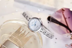 Detailed shot of silver quartz watch with chain strap on an elegant lifestyle background