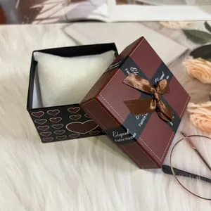 Elegant square watch gift box with brown ribbon bow and soft white cushion padding