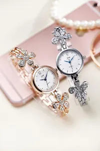 Detail showing elegant flower shaped metal bands with rhinestones on quartz watches