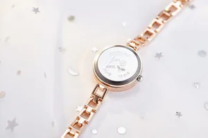 Detailed macro view of the stainless steel back with flower engraving on rose gold watch
