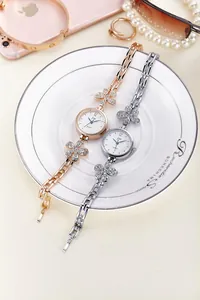 Close-up of elegant flower-shaped bracelet watches with crystals in rose gold and silver