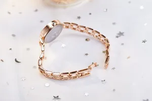 Detailed back view of a rose gold women's watch with elegant chain strap and fold-over clasp
