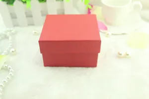 Macro detail of square dark red gift box with a textured finish on a plush white background