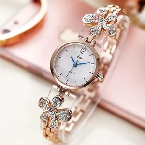 Rose gold fashion watch for women with flower crystal accents and blue hands