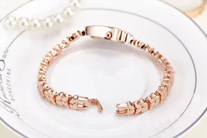 Elegant rose gold heart bracelet watch with jewelry clasp and rhinestone details