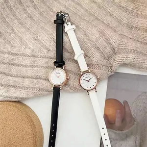 Detail view of stylish women's watches with leather straps and rose gold sunray dials
