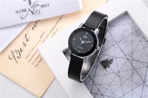 Detail of minimalist women's watch A-5707 with black dial and silver case on a white frame