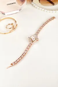 Detail of rose gold rhinestone leaf bracelet watch with small rectangular quartz dial