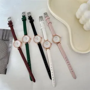 Detail of five stylish women's leather strap quartz watches with rose gold cases and dials
