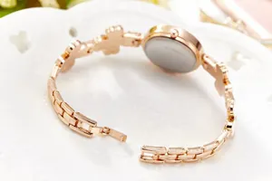 Detail view of rose gold flower bracelet watch clasp and stainless steel back case