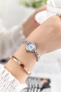 Detailed shot of a women's quartz watch with a heart-shaped silver metal bracelet strap