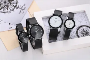 Detail of minimalist quartz watches with black and white dials on a vintage map background