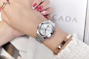 Close-up of stylish silver steel watch for women featuring a white multi-dial quartz face