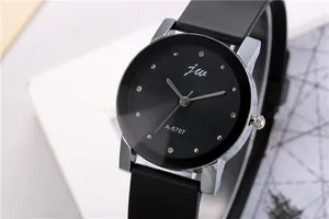 Macro shot of a stylish black dial quartz watch with silver casing and rhinestone markers