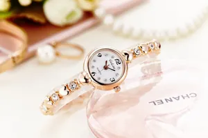 Detailed close-up of a women's rose gold heart-link watch with sparkling crystal accents