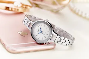 Close-up of elegant silver stainless steel watch with white dial and blue sword hands