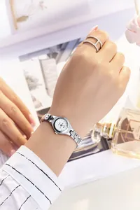 Elegant silver quartz watch with rhinestone markers on a dainty chain bracelet strap