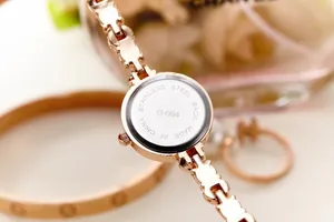 Detail of rose gold watch case back in stainless steel with elegant link bracelet