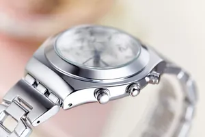 Close-up of silver stainless steel watch case and buttons with elegant polished finish
