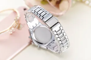 Close-up of silver stainless steel three-link watch strap with folding buckle detail