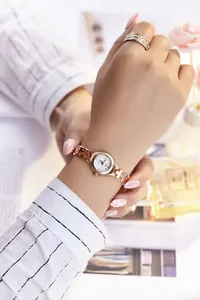 Close-up of rose gold quartz watch with a jewelry-style bracelet and diamond markers
