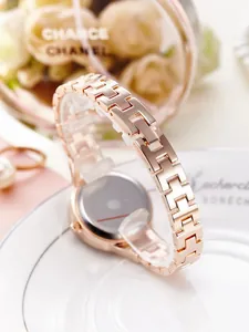 Close-up of rose gold stainless steel watch band with elegant H-link design and jewelry