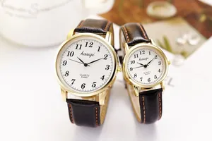Detailed close-up of quartz watch set with black leather strap and white dial