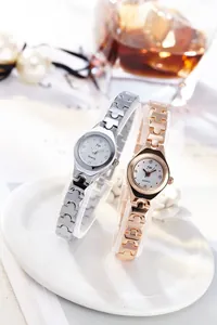 Detail of silver and rose gold quartz watches with geometric chain link bracelets