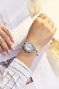 Detailed view of silver women's quartz watch with rhinestone bezel and bracelet band