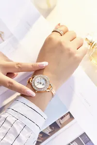 Detail of rose gold quartz watch set with rhinestones and matching crystal ring