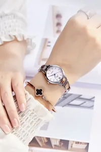 Elegant women's silver steel watch with pink dial paired with a clover bracelet