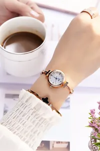 Detailed set featuring a rose gold quartz watch with minimalist dial and metal bracelet