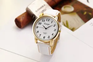 Close-up of quartz watch with white leather strap and large dial with Arabic numerals