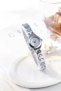 Detail of silver quartz watch with rhinestone markers on white display stand
