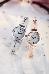 Detailed close-up of fashion watches with rose gold finish and silver glitter dial