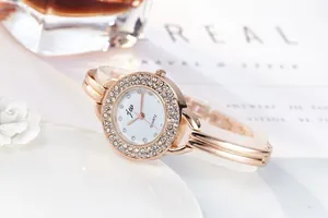 Macro shot of rose gold quartz watch featuring double rhinestone bezel and jw logo