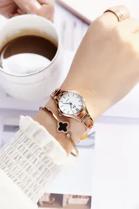 Elegant rose gold watch set with clover bracelet and diamond ring on model wrist