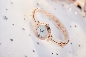 Detailed macro view of a rose gold fashion watch featuring a silver glitter dial and jw logo