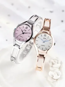 Macro shot of silver and rose gold steel strap watches with quartz movement logos