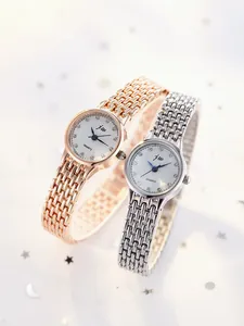 Detail of rose gold and silver quartz bracelet watches with elegant crystal markers
