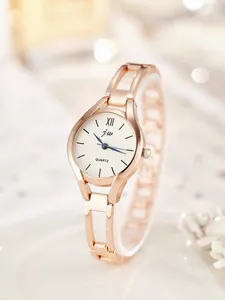 Detail of rose gold bangle watch with white dial, blue hands and roman numeral markers
