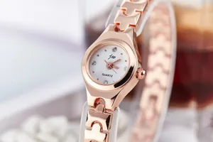 Detail view of the rose gold steel band watch with crystal markers and white dial