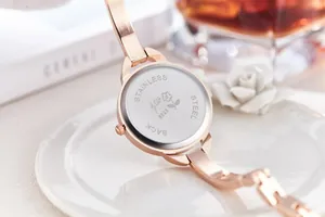 Macro view of rose gold watch back with stainless steel engraving and serial 8325