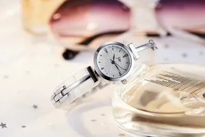 Close-up of stylish ladies' watch with silver glitter dial and resin metal strap