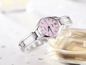 Detail showing elegant silver hollow steel band and pink quartz watch dial