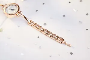 Macro detail of the rose gold link strap and jewelry clasp on this elegant quartz watch
