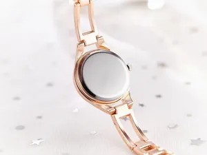 Macro shot of rose gold fashion watch with stainless steel back on starry white gauze