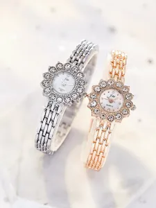 Close-up of luxury women's watches featuring flower-shaped diamond bezels and metal bands
