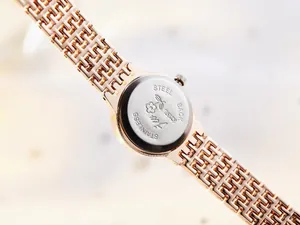 Detail of rose gold steel watch back featuring engraved floral patterns and Misty logo