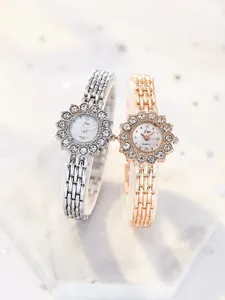 Detail view of silver and rose gold quartz watches with rhinestone sunflower dials